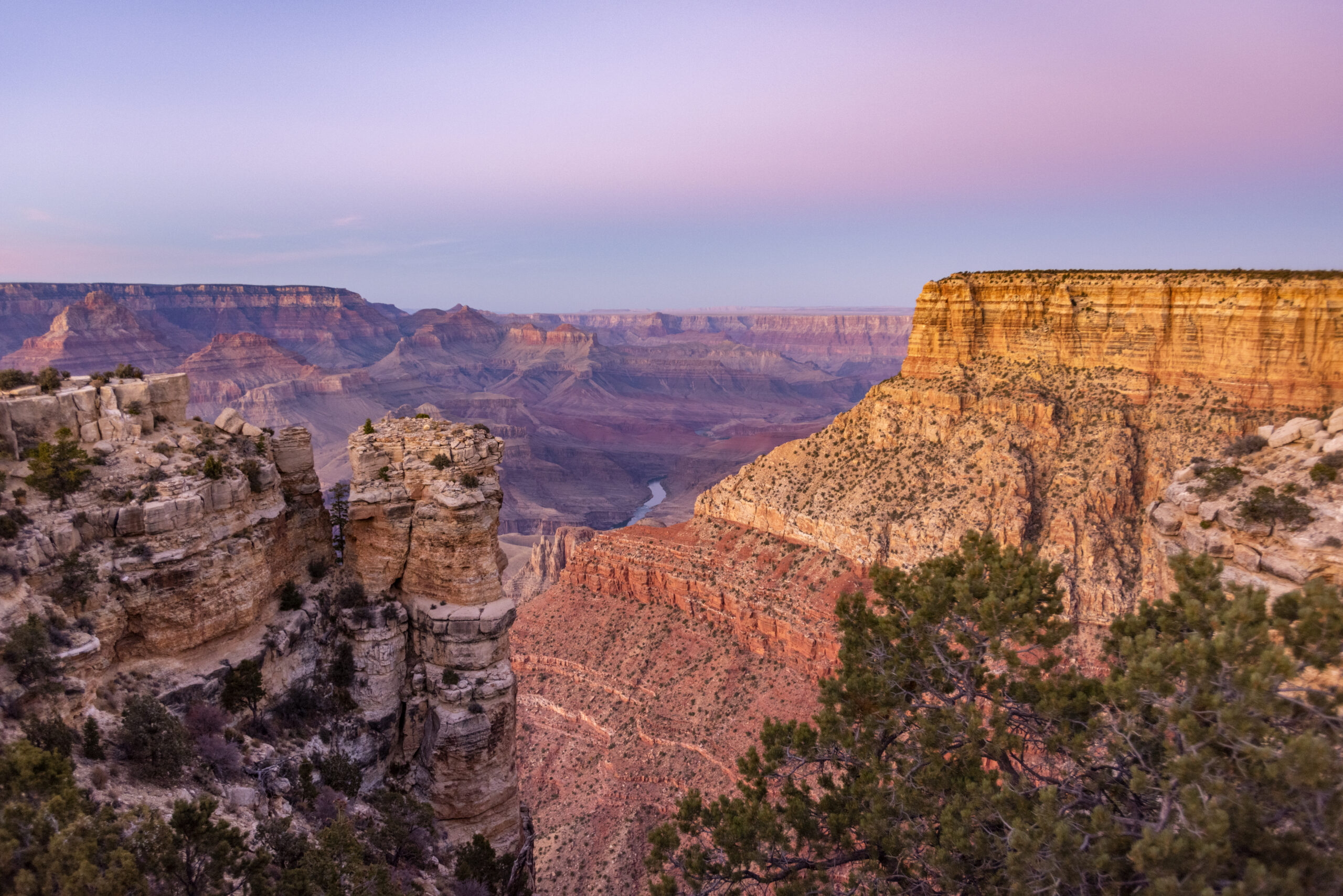 A view of the Colorado River weaving through valleys and rugged Grand Canyon terrain at Moran Point.